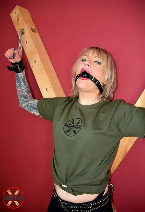 Tattooed Blonde Bound to Cross with Ball Gag in Shorts – photo 16 of 16
