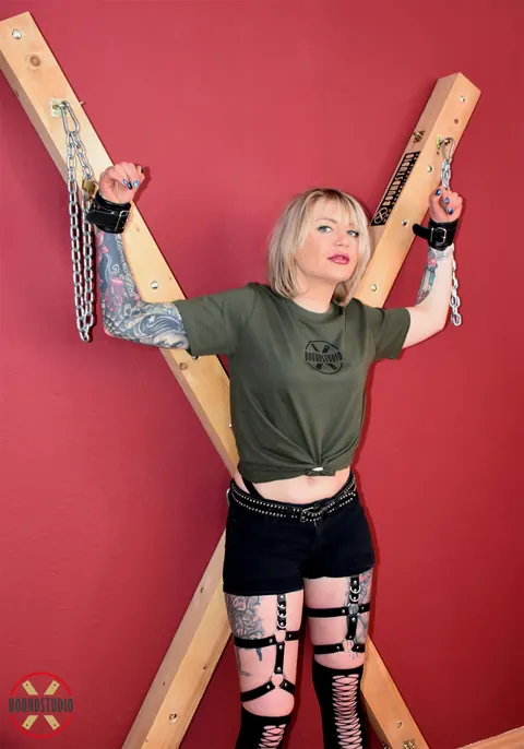 Tattooed Blonde Bound to Cross with Ball Gag in Shorts – photo 12 of 16