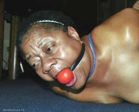 Curvy Mature Ebony Woman Endures Strict Hogtie and Ball Gag – photo 15 of 16