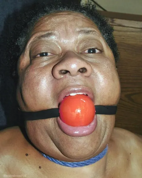 Curvy Mature Ebony Woman Endures Strict Hogtie and Ball Gag – photo 14 of 16