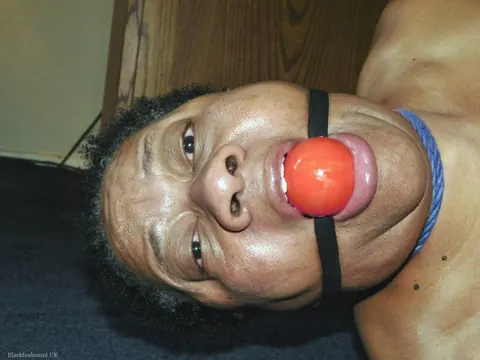 Curvy Mature Ebony Woman Endures Strict Hogtie and Ball Gag – photo 3 of 16