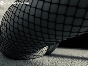 Woman in Fishnet Pantyhose and Heels Poses with a Strap-On
