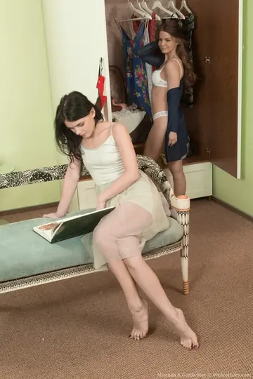 Two Brunettes in Lingerie and Socks Share a Dildo