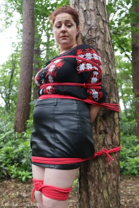 Thick Redhead in a Skirt and Leather Bound to a Tree – photo 8 of 16