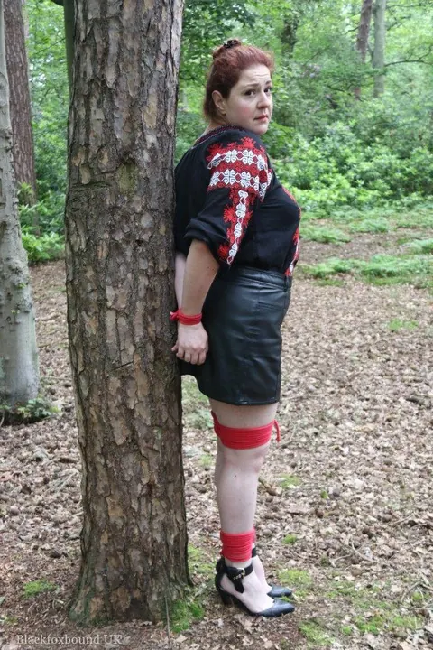 Thick Redhead in a Skirt and Leather Bound to a Tree – photo 1 of 16