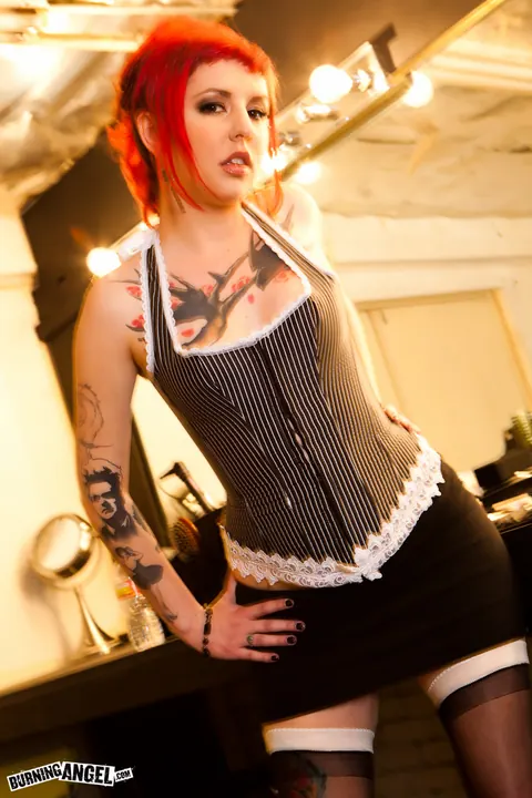 Redhead Sheds Her Costume and Fingers Her Pussy – photo 2 of 17