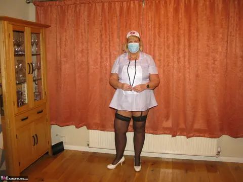 Curvy MILF Strips Out of Her Nurse Uniform into Lingerie – photo 1 of 16