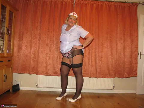 Curvy MILF Strips Out of Her Nurse Uniform into Lingerie – photo 10 of 16
