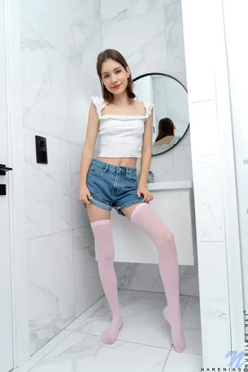Slim Short-Haired Babe Uses a Dildo on Her Shaved Pussy in the Bathroom