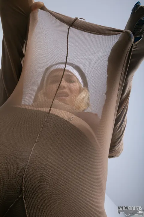 Woman in a Nun Uniform Strips and Layers Pantyhose Over Stockings – photo 12 of 16