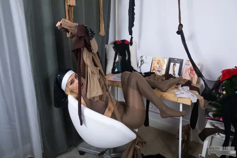 Woman in a Nun Uniform Strips and Layers Pantyhose Over Stockings – photo 9 of 16