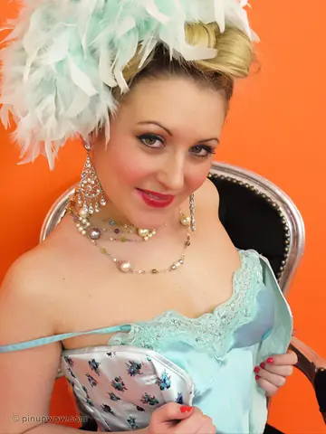Thick Pinup Model Strips Out of Her Corset and Models White Fishnet Lingerie