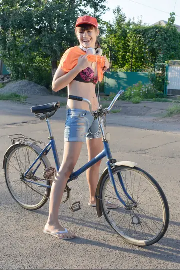 Tall Slim Brunette Undresses and Spreads by a Bike Outdoors
