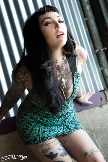 Busty Brunette Spreads Her Shaved Pussy Showing Her Tattoos