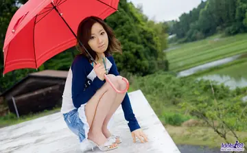Asian Brunette in a Skirt and Bikini Pulls Down Her Panties