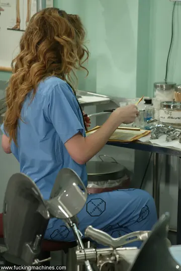 Brunette MILF in a Doctor Uniform Rides a Sex Machine in the Office