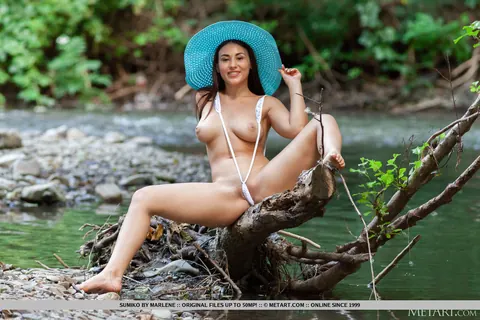 Brunette in a Bikini Spreads Her Shaved Pussy at a Stream – photo 7 of 18