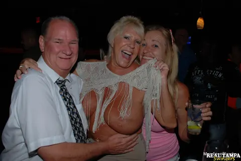 Mandi McGraw: Tall Blonde MILF with Enhanced Tits Undresses for Public Group Sex – photo 17 of 20
