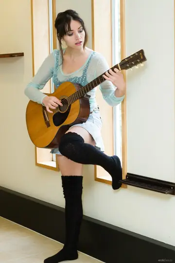 Woman in Stockings Strips with Guitar and Spreads Her Hairy Pussy