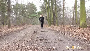 Hairy Woman in Glasses Squats and Pisses on a Dirt Road