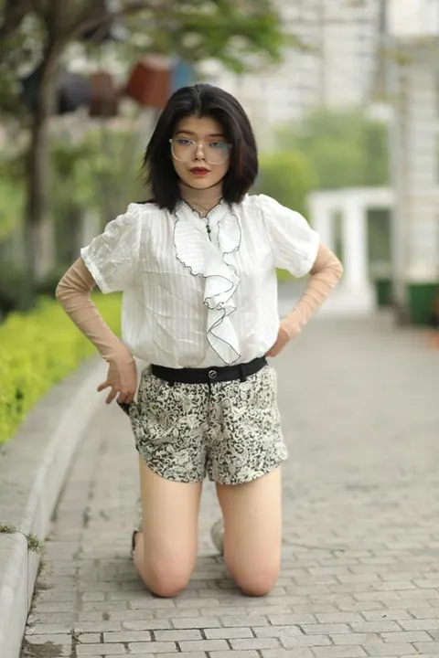 Asian Brunette in Glasses Poses Outdoors in Shorts – photo 19 of 21