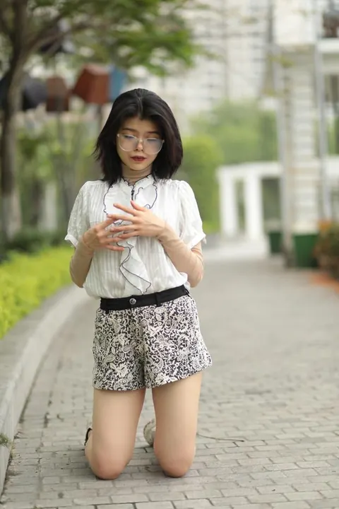 Asian Brunette in Glasses Poses Outdoors in Shorts – photo 16 of 21
