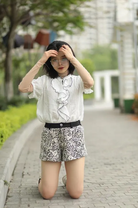 Asian Brunette in Glasses Poses Outdoors in Shorts – photo 15 of 21