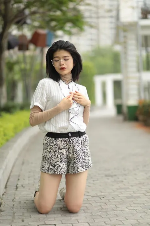 Asian Brunette in Glasses Poses Outdoors in Shorts – photo 13 of 21