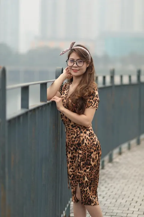 Asian Woman in a Skirt and Glasses Poses Outdoors – photo 16 of 21