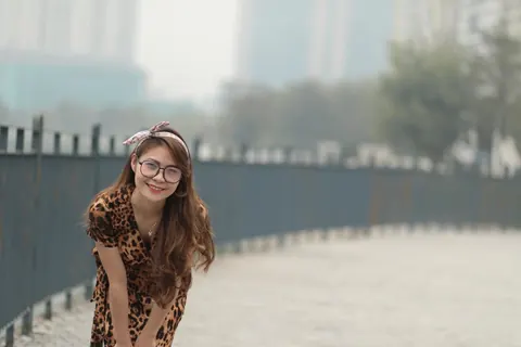 Asian Woman in a Skirt and Glasses Poses Outdoors – photo 11 of 21
