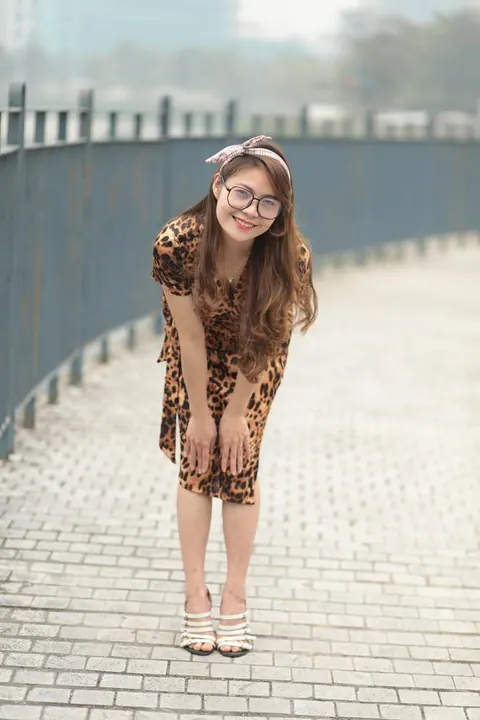 Asian Woman in a Skirt and Glasses Poses Outdoors – photo 9 of 21