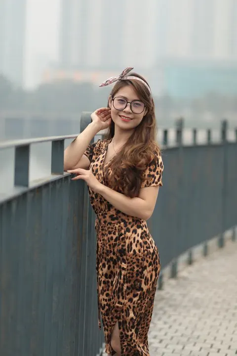 Asian Woman in a Skirt and Glasses Poses Outdoors – photo 18 of 21