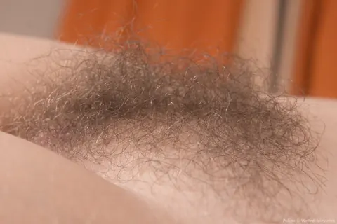 Brunette with Big Tits Pulls Shorts Down to Show Her Hairy Pussy – photo 19 of 21