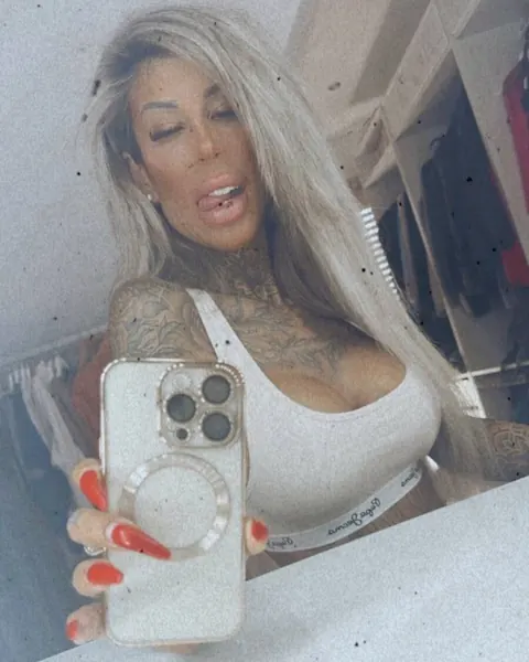 Tattooed Amateur Poses in a Thong and Shows Her Ass – photo 15 of 16