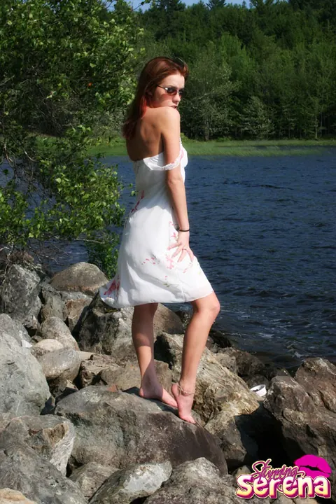Stunning Serena: PAWG Redhead in a Skirt and Glasses Poses on Waterside Rocks – photo 1 of 12