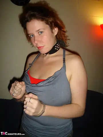 European Redhead in a Skirt and Boots Masturbates While Gagged and Cuffed