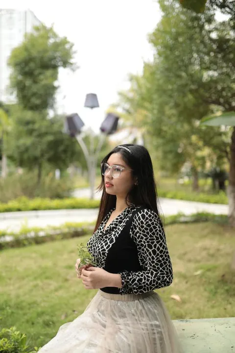 Asian Brunette in Glasses and Skirt Poses Outdoors – photo 1 of 21
