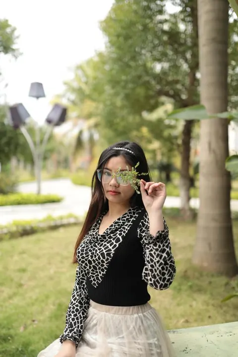 Asian Brunette in Glasses and Skirt Poses Outdoors – photo 3 of 21
