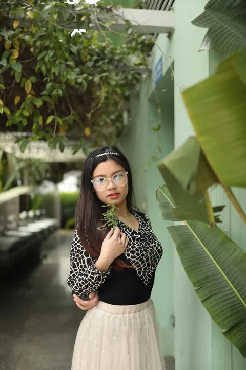Asian Brunette in Glasses and Skirt Poses Outdoors – photo 14 of 21