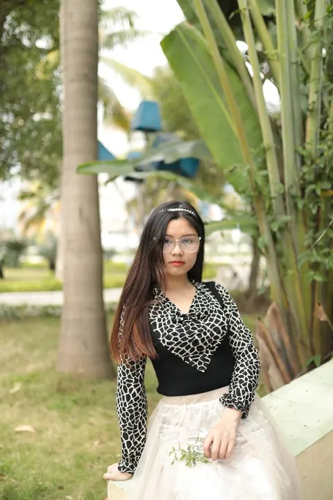 Asian Brunette in Glasses and Skirt Poses Outdoors – photo 6 of 21