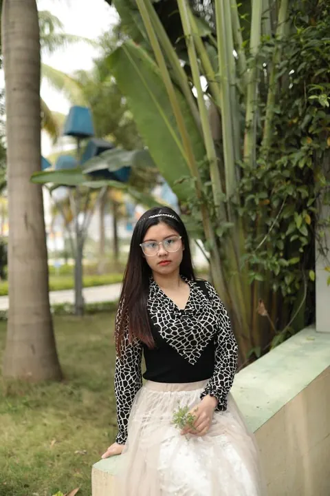 Asian Brunette in Glasses and Skirt Poses Outdoors – photo 7 of 21