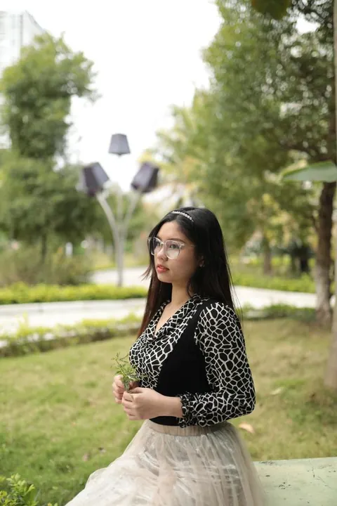 Asian Brunette in Glasses and Skirt Poses Outdoors – photo 21 of 21