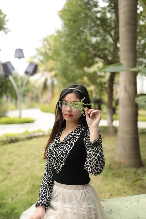 Asian Brunette in Glasses and Skirt Poses Outdoors – photo 4 of 21