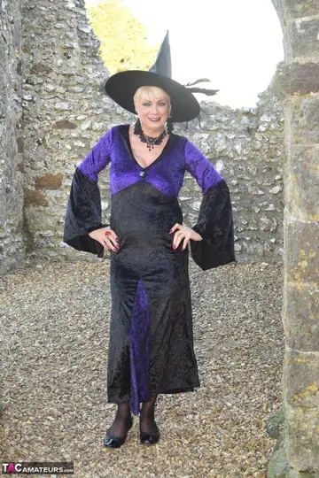 Short-Haired Blonde in Costume Lingerie Spreads Outdoors