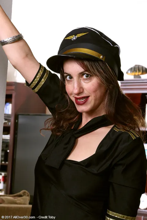 Sophya Love: Thick Mature Brunette Strips Out of Her Flight Attendant Uniform and Spreads – photo 1 of 16