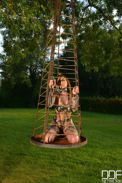 Lauren Brock: Inked Brunette in Lingerie Poses Chained in an Outdoor Cage – photo 17 of 21