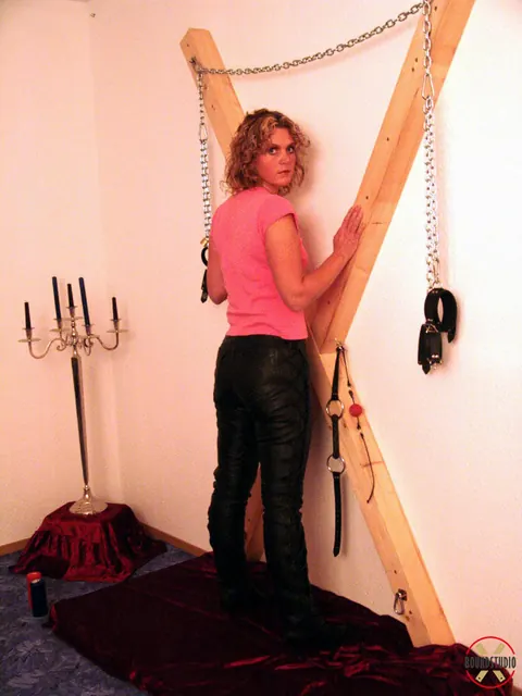 Blonde in Boots and Skirt Restrained on a Cross – photo 1 of 16