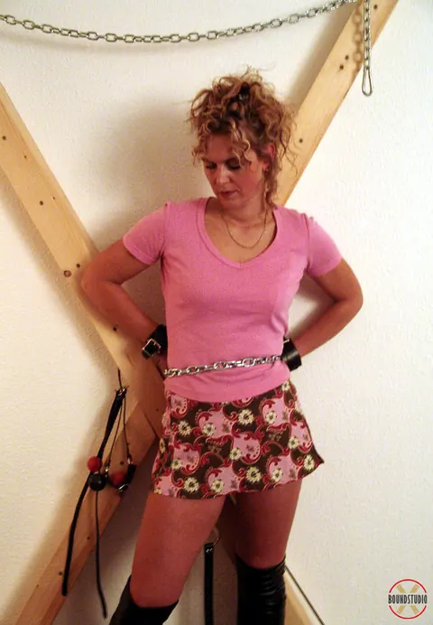Blonde in Boots and Skirt Restrained on a Cross – photo 9 of 16