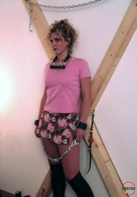 Blonde in Boots and Skirt Restrained on a Cross – photo 15 of 16