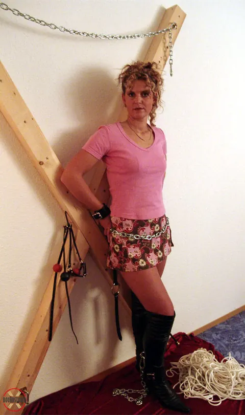 Blonde in Boots and Skirt Restrained on a Cross – photo 10 of 16